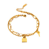 Flat lay of heart lock bracelet next to soft fashion accessories